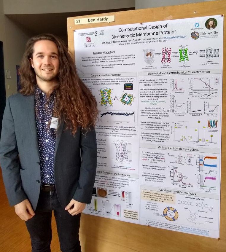 Ben Hardy stands next to his prize-winning poster at APFED-22.
